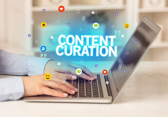 Freelance woman using laptop with CONTENT CURATION inscription, Social media concept