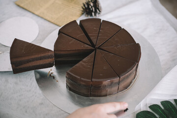 Sliced chocolate cake on a steel plate.