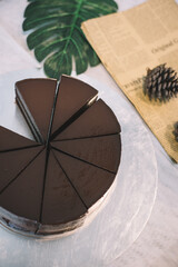 Sliced chocolate cake on a steel plate.