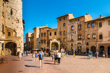 Gorgeous view of the Piazza della Cisterna, main square of San Gimignano in Tuscany. Named after the underground cistern, capped by an octagonal pedestal built in 1346, it's a tourist attraction now.