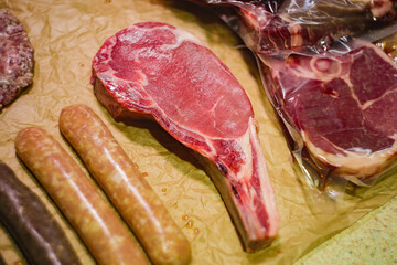 a piece of steak lies on a wooden board