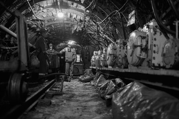 Silhouette of a working miner in a mine