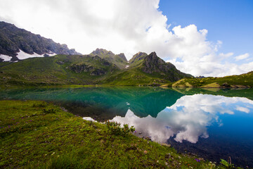 Naklejka na ściany i meble Alpine mountain lake landscape and view, blue beautiful and amazing lake panorama