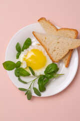 scrambled eggs with bread and basil close-up.