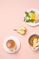healthy breakfast of coffee and scrambled eggs on a pink background.