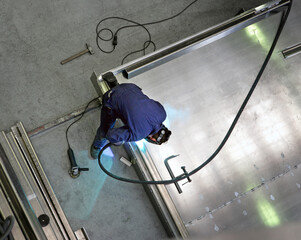 Welding in a aluminum hull of a super sailing yacht. Shipbuilding industry.