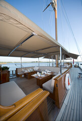 Deck of a classic wooden sailing yacht. Netherlands. Dinner table laid.