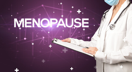 Doctor fills out medical record with MENOPAUSE inscription, medical concept