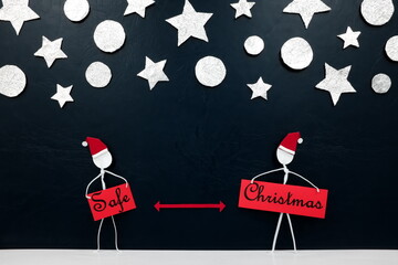 Stick men figure wearing santa hat with red distance marker in between and silver stars and balls ornament background. Safe covid Christmas greeting concept.