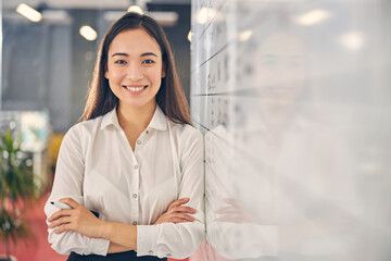 Joyful young woman looking straight at camera