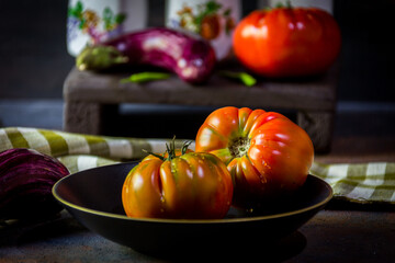 Preparation with vegetables on dark ground in the kitchen