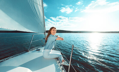 Happy Woman Sitting On Sailboat Deck Smiling To Camera Outdoors