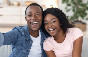 Closeup portrait of african lovers taking selfie together