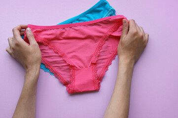 Set of women's panties on a pink background. Pink and blue underwear.