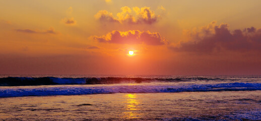 Fototapeta na wymiar Bright red sunrise over the sea. Wide photo.