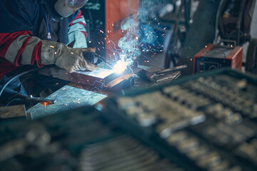 Close up of concentrated worker welding parts
