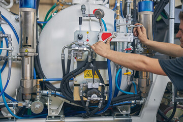 Competent mechanic doing checkup of pressure in unit