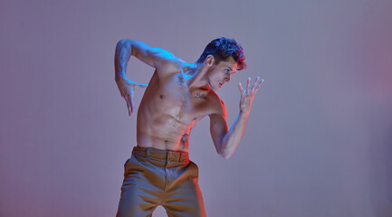 Cool young guy professional dancer dance without shirt in neon light. Colorful dance school poster. Break dance lessons