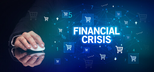 hand holding wireless peripheral with FINANCIAL CRISIS inscription, online shopping concept