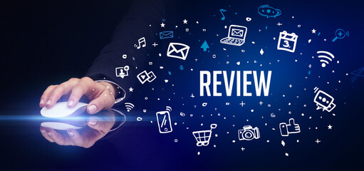 hand holding wireless peripheral with REVIEW inscription, social media concept