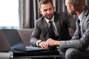 business men co-working with laptop, two guys have successful cooperation, have talk, discuss...
