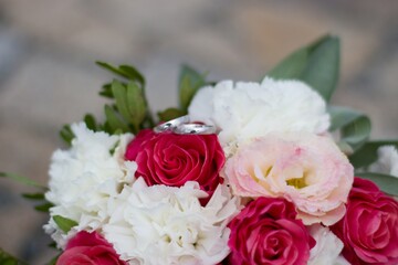 festive bouquet of pink-white with wedding rings