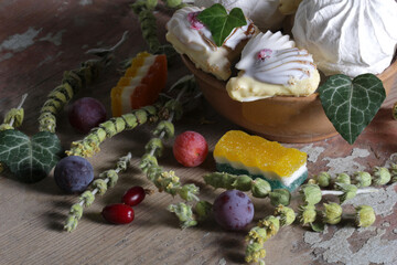 Sweet dessert with berries and leaves on a wooden table