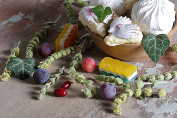 Sweet dessert with berries and leaves on a wooden table