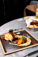 beautifully decorated steak on plate in restaurant, tasty restaurant food. cuisine, restaurant, food concept