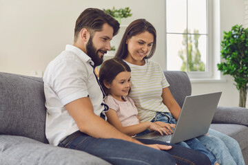 Happy family with laptop doing online shopping in the online store remotely at home.