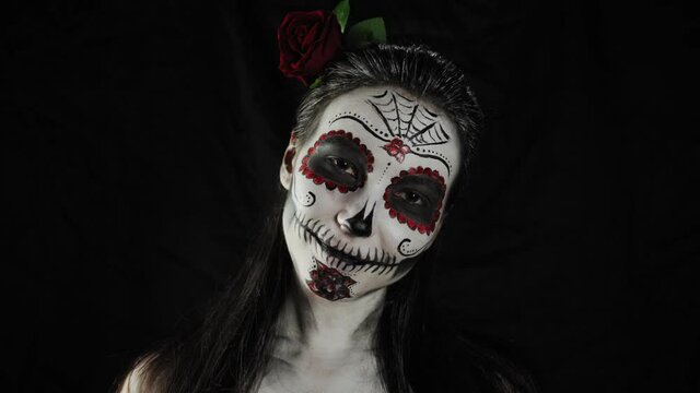 Halloween, Day of the Dead. Portrait of a young woman with Calavera Katrina makeup.