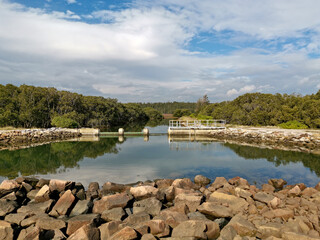 Beautiful view of a pond in a nature reserve with reflections of blue sky, light clouds and trees on water, Newington Nature Reserve, Newington, Sydney, New South Wales ,Australia