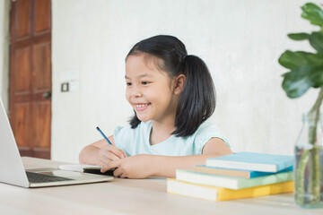 pretty  stylish schoolgirl studying homework during online lesson at home, social distance during quarantine, self-isolation, online education concept, home school, study online video call teacher.