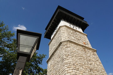 Clock tower and lamp in the old town of Dobrich, Bulgaria