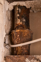 Rusted built-in cast iron sewer pipe damaged with a crack