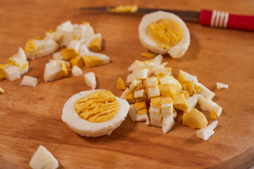 cut chicken eggs on a wooden background