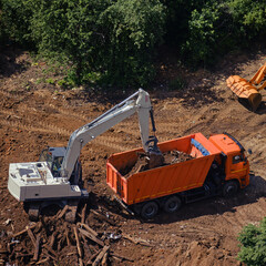 Construction in a park with green trees, top view