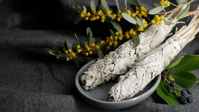 Dried white sage smudge stick, relaxation and aromatherapy. Smudging during psychic occult ceremony, herbal healing, yoga or aura cleaning. Essential incense for esoteric rituals and fortune telling.
