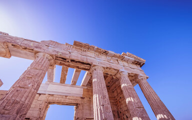 Fototapeta premium Greece, Propilea of Athens acropolis under deep blue sky and direct sunlight
