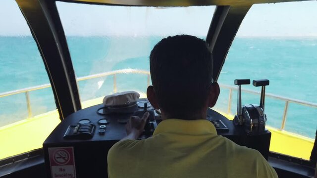 Hurghada, Egypt - 14 Sep, 2019: Male captain hands on boat steering wheel, yachting, sailing. Luxury hobby for rich people. Active lifestyle