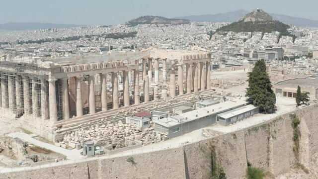 Close up Aerial flight over Acropolis on Mountain over Athens, Greece at Daylight