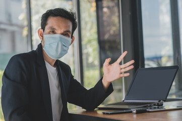 Asian man a wearing face mask use computer freelancer working from home,Concept business technology,new normal  social distancing