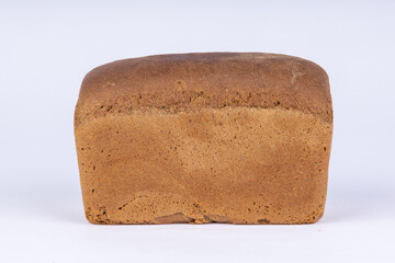 a loaf of fresh rye bread on a white background