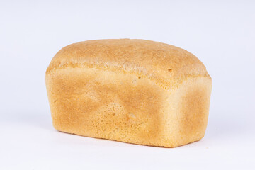 a loaf of fresh wheat bread on a white background