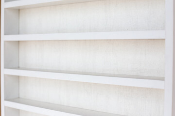 White Wooden Shelf on a Wall in Light Room.