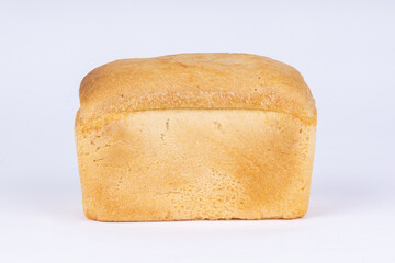 a loaf of fresh wheat bread on a white background