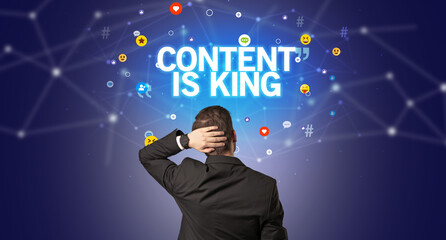 Rear view of a businessman with CONTENT IS KING inscription, social networking concept