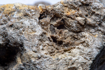 Stone surface texture at high magnification with numerous chips and small details