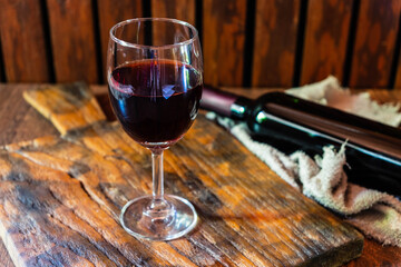 .Wine glass and wine bottle on the wooden table