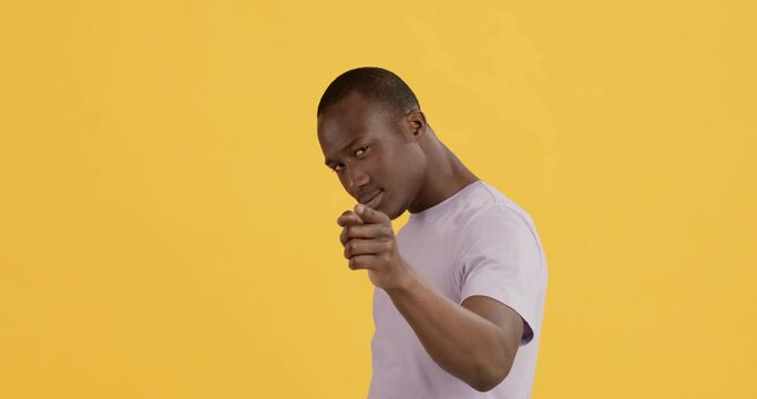 Playful african american guy pointing to camera, choosing you